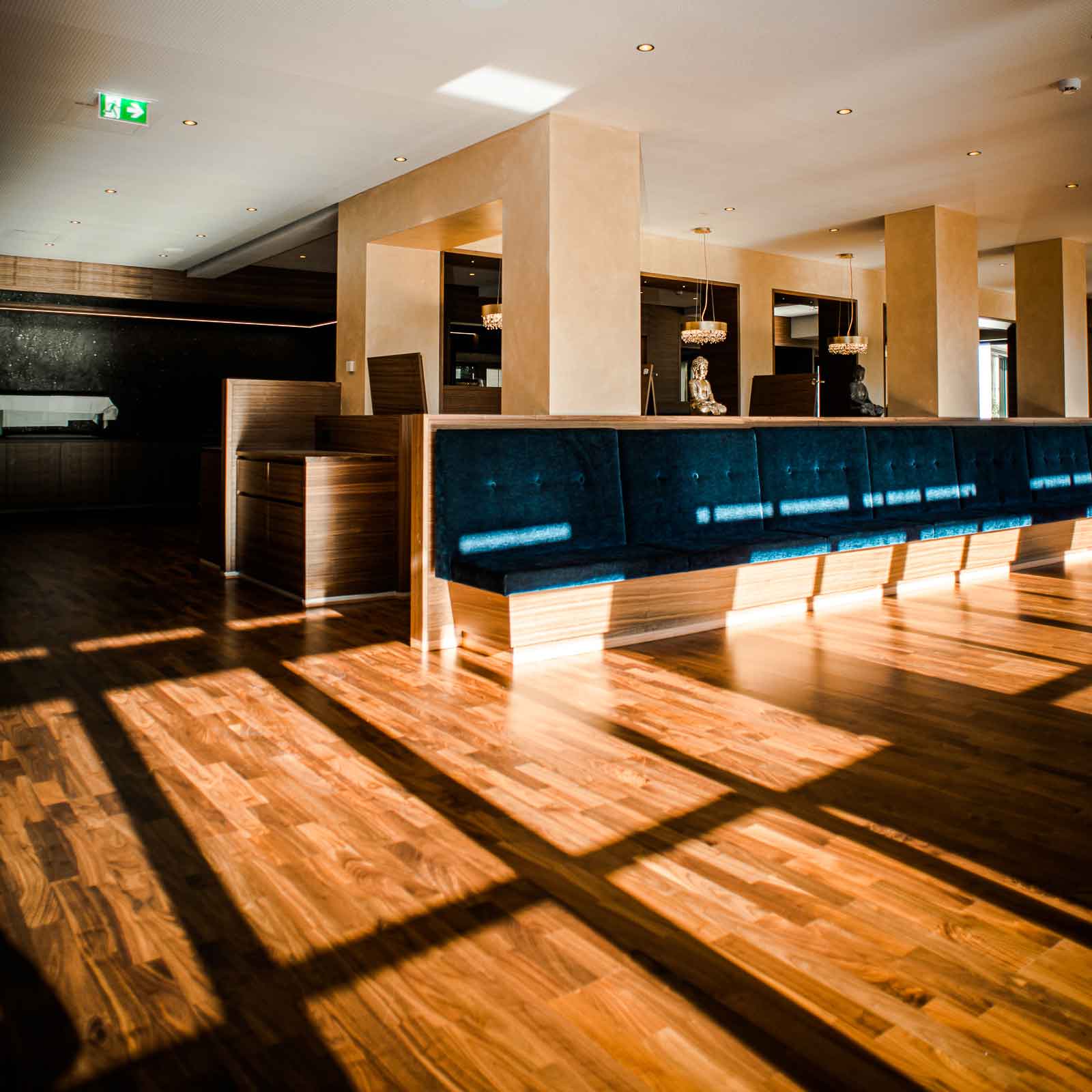 Bild zeigt Empfangsbereich des sanierten Holzbodens im Ayurveda Resort Mandira in der Steiermark.